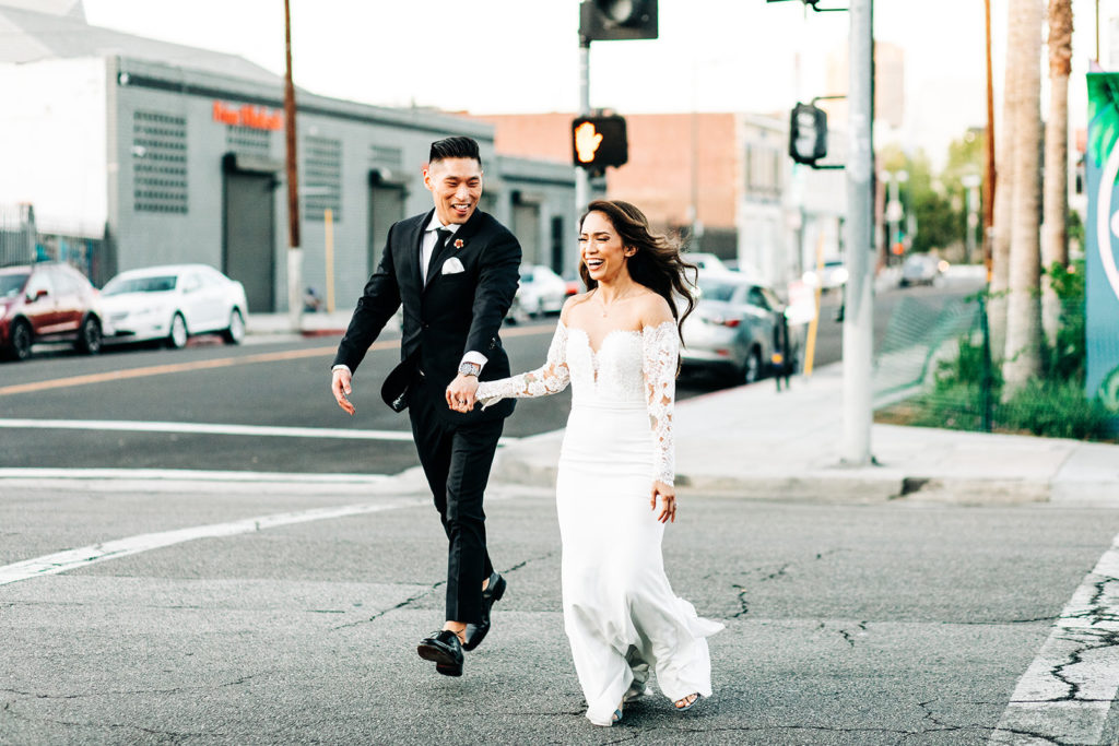 bride and groom walking across the street in los angeles outside of valentine DTLA