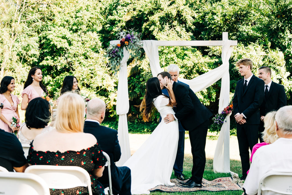 Camarillo wedding photography ; bride and grooms first kiss at wedding