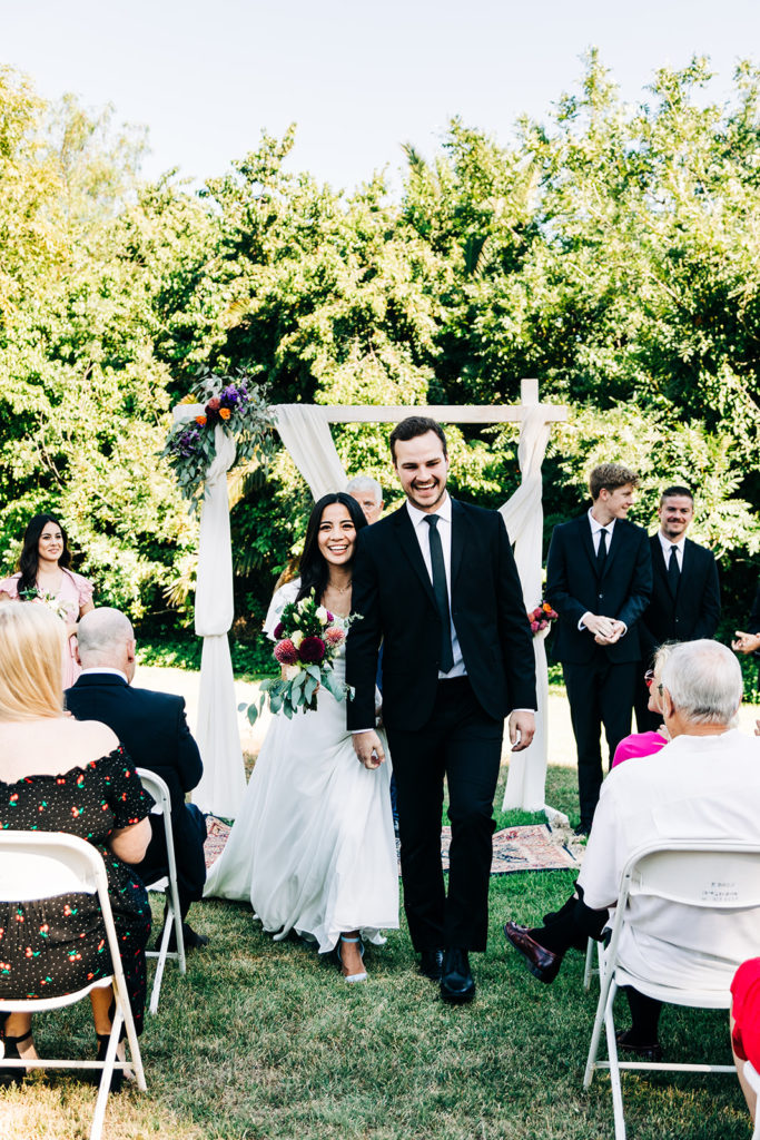 Camarillo wedding photography ; bride and groom walking back up the aisle
