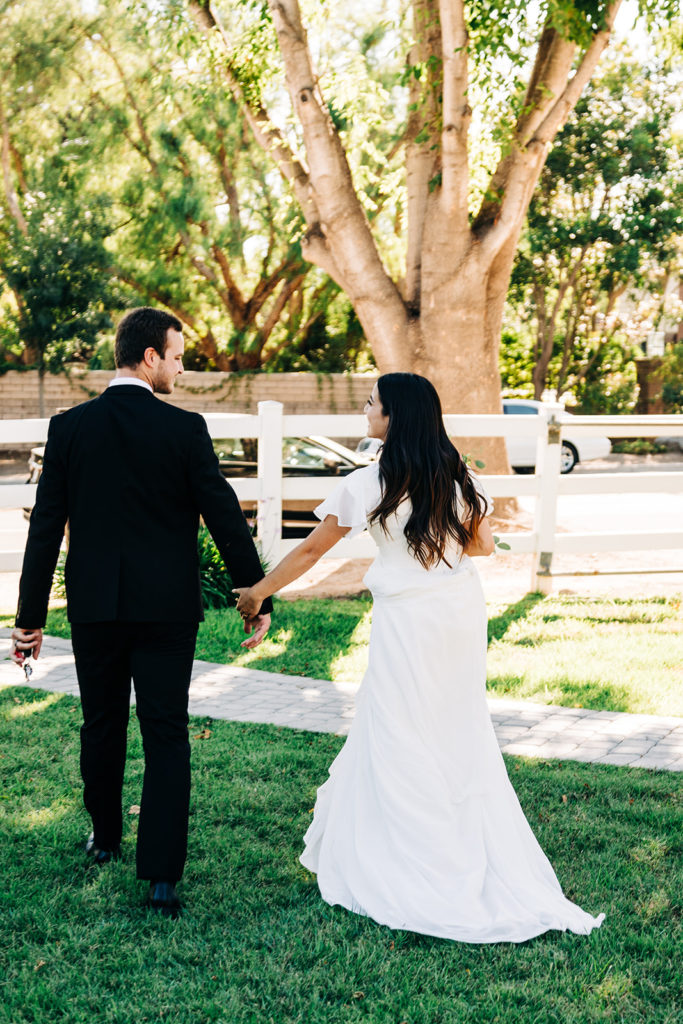 Camarillo wedding photography ; bride and groom holding hands after ceremony