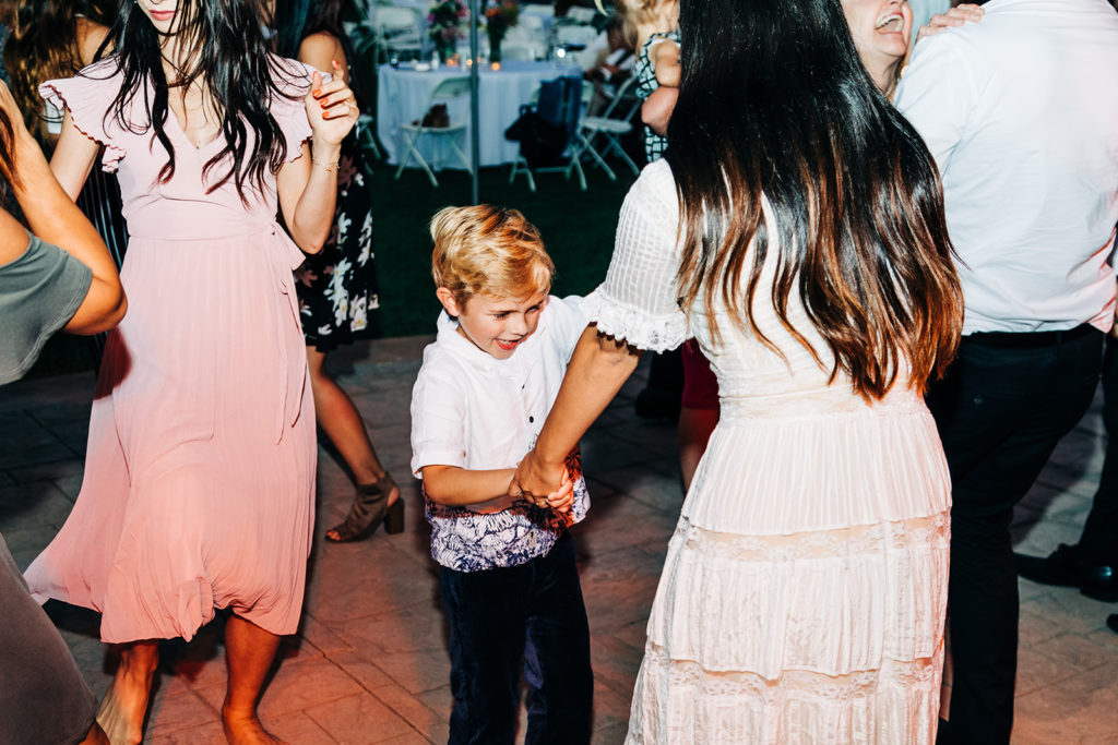 Camarillo wedding photography ; kid dancing with bride at outdoor wedding reception