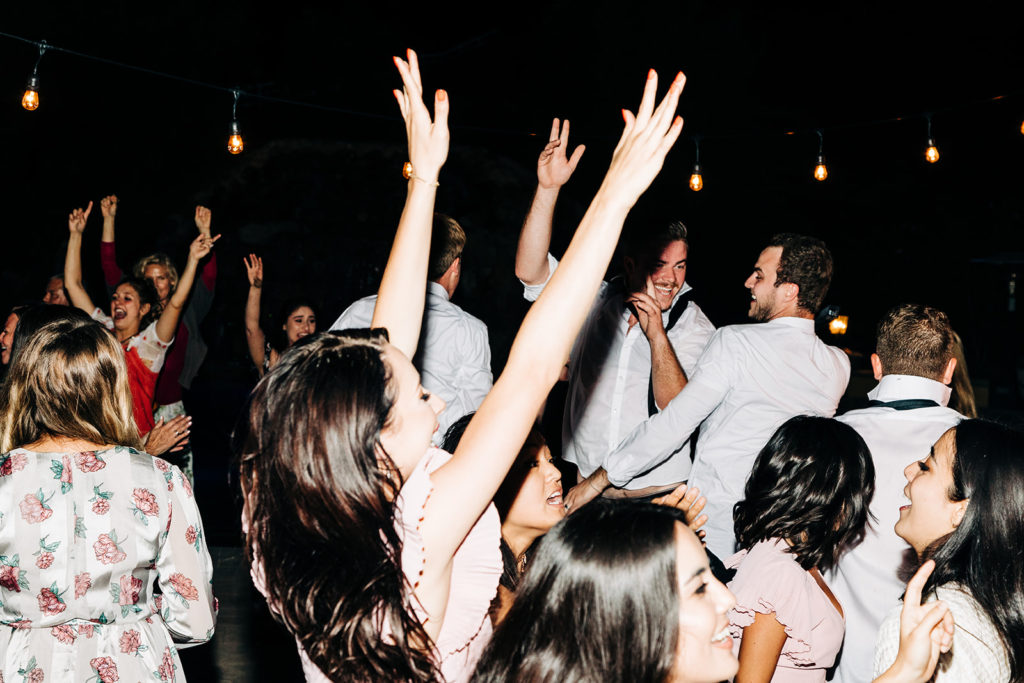 Camarillo wedding photography ; wedding guests jumping on the dance floor at wedding reception