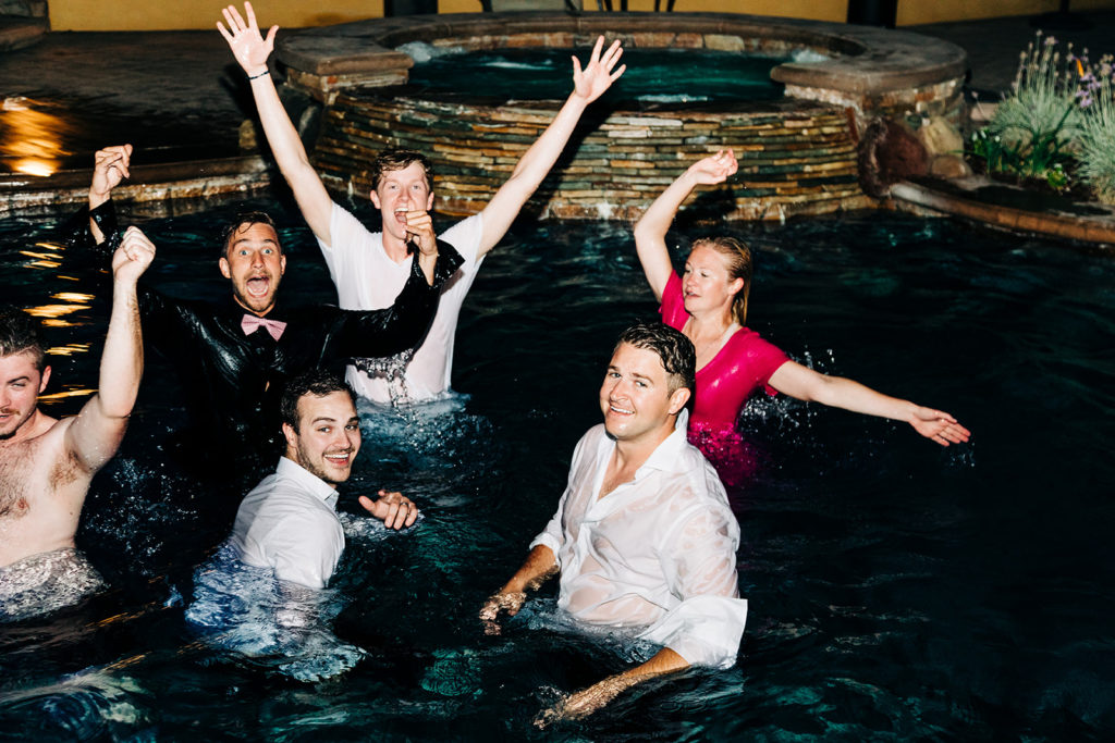 Camarillo wedding photography ; wedding guests jump in the pool after the wedding reception