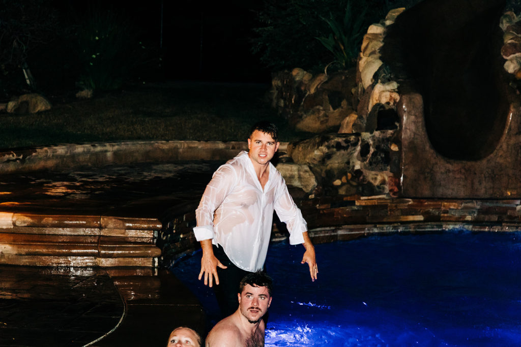 Camarillo wedding photography ; guests in pool water after wedding reception