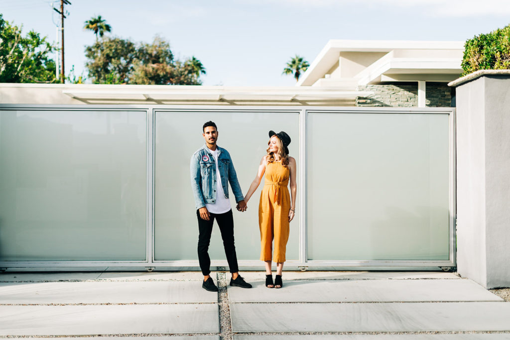 southern california engagement photos; couple standing holding hands in palm springs