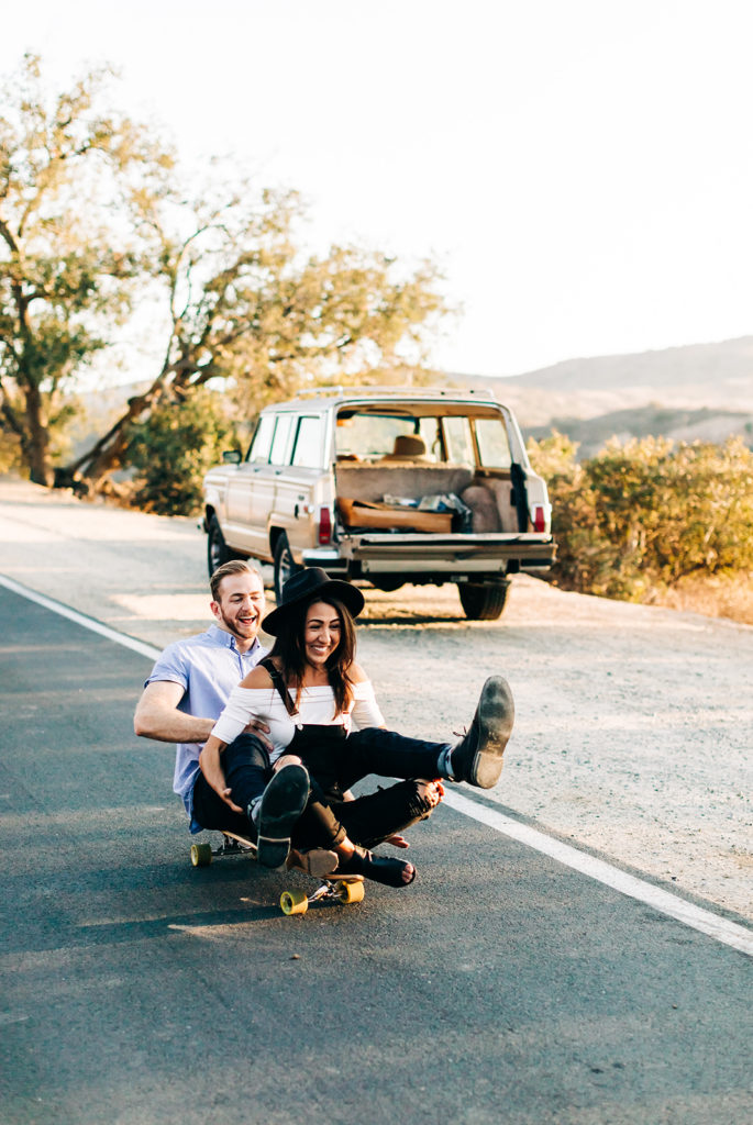 southern california engagement photos; couple sitting on a skateboard