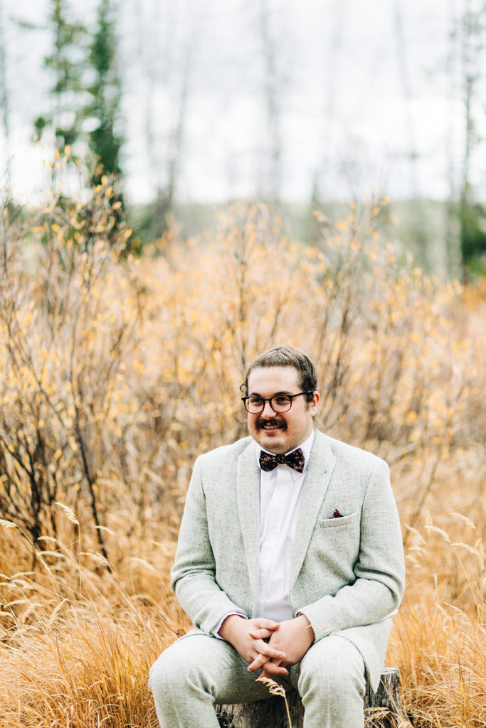 Redfish Lake Lodge wedding photography ; groom waiting to see bride in a field
