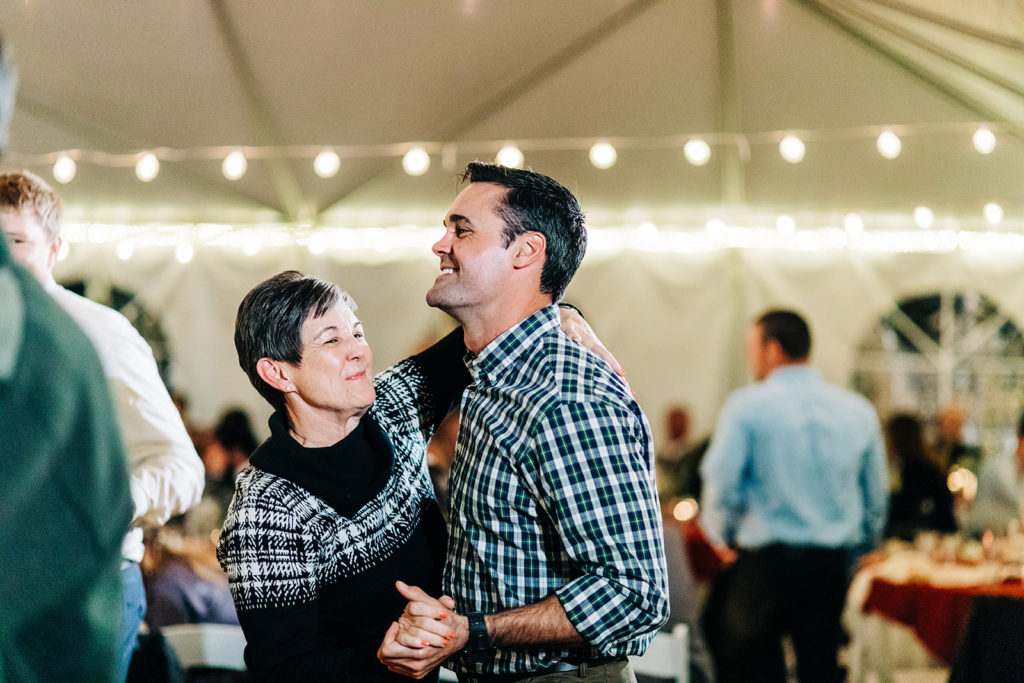 Redfish Lake Lodge wedding photography ; wedding guests dance together in plaid