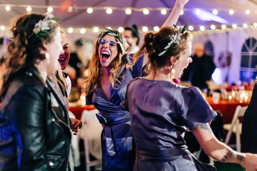 Redfish Lake Lodge wedding photography ; bridesmaid laughing while dancing