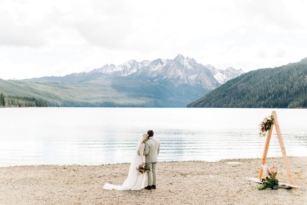 Redfish Lake Lodge wedding photography ; bride and groom pose on a lake