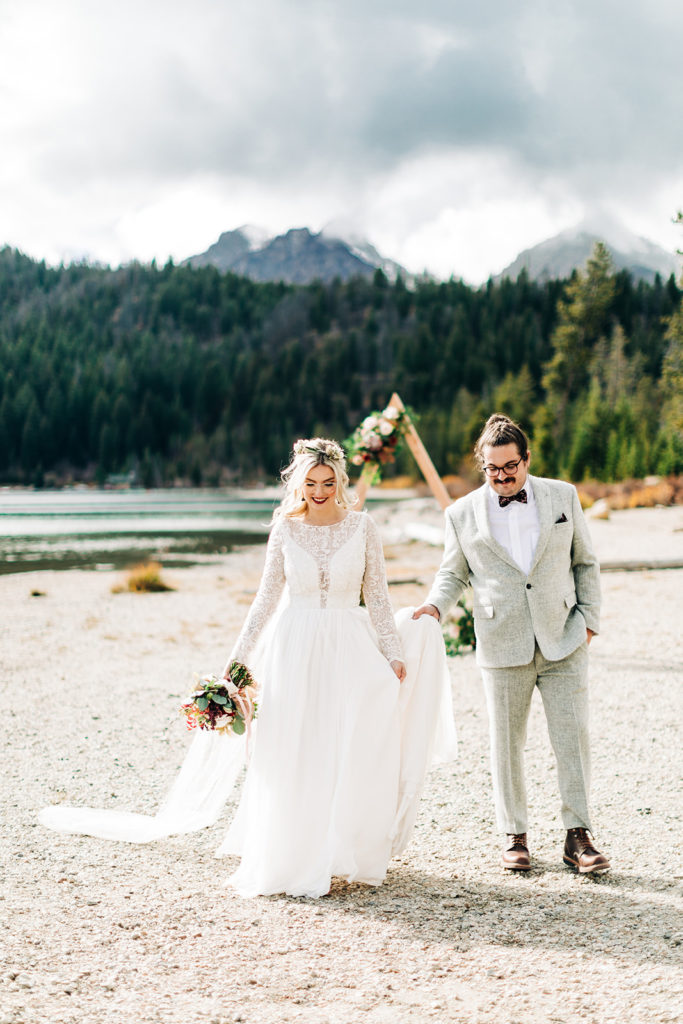 Redfish Lake Lodge wedding photography ; bride and groom walk on the sand
