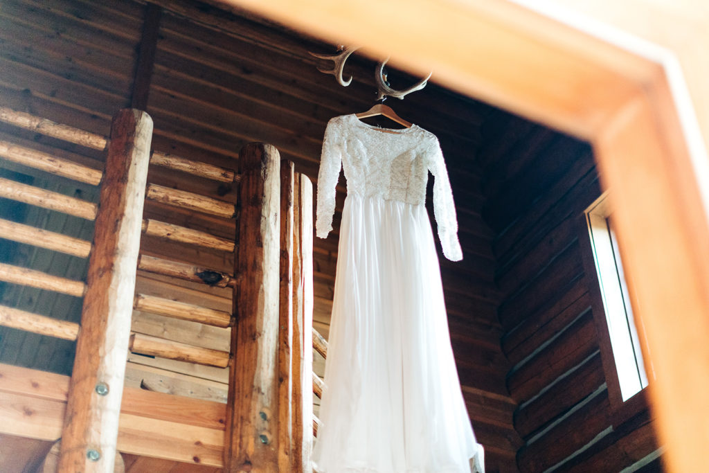 Redfish Lake Lodge wedding photography ; wedding dress hanging from antlers