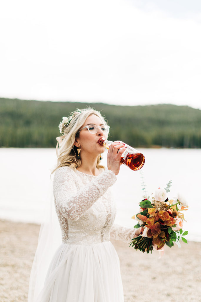 Redfish Lake Lodge wedding photography ; bride drinks whiskey before wedding ceremony