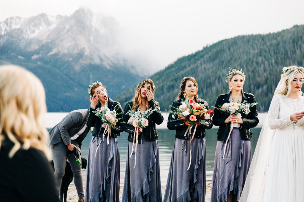 Redfish Lake Lodge wedding photography ; bridesmaids in silver dresses wipe tears