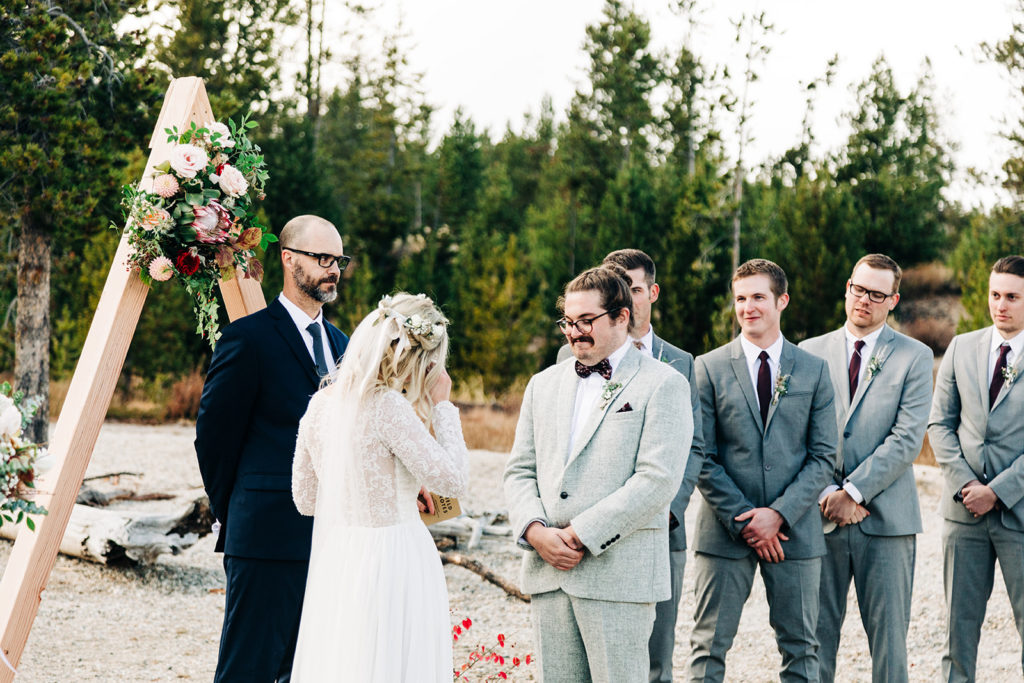 Redfish Lake Lodge wedding photography ; bride wipes away tears during ceremony