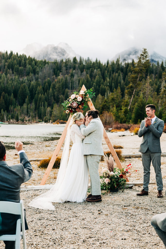 Redfish Lake Lodge wedding photography ; bride and groom kiss at wedding ceremony