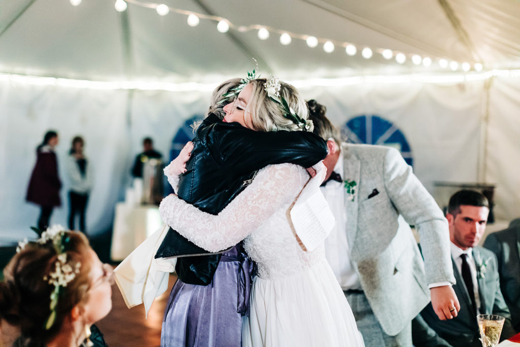 Redfish Lake Lodge wedding photography ; bride hugs bridesmaid