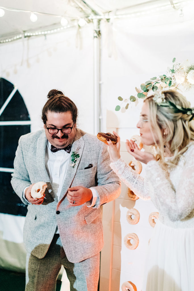 Redfish Lake Lodge wedding photography ; bride and groom eat donuts after wedding