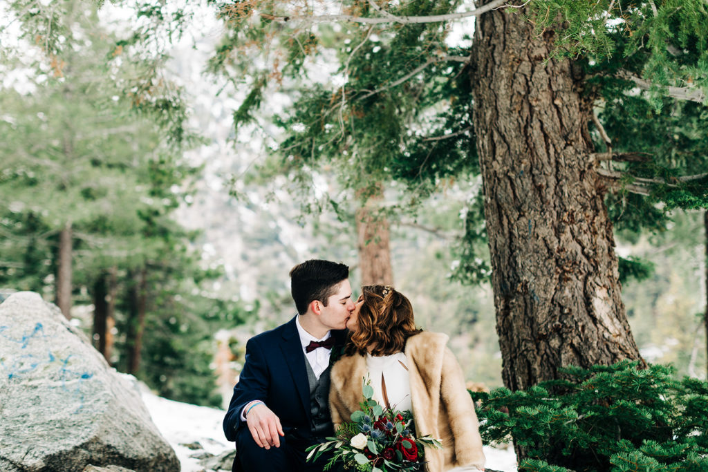 Mt. Baldy wedding photography ; bride and groom kiss in snowy forrest