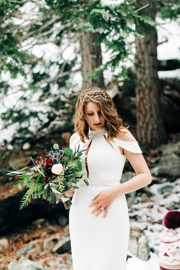 Mt. Baldy wedding photography ; bride poses in snow holding a bouquet