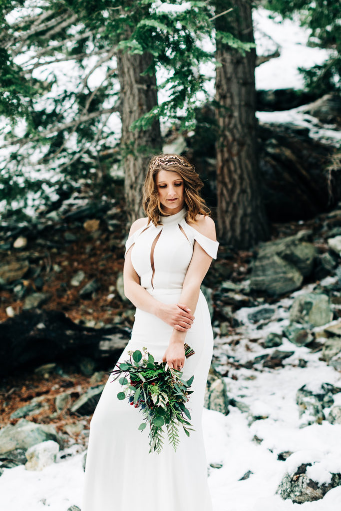 Mt. Baldy wedding photography ; bride stands in snowy forrest