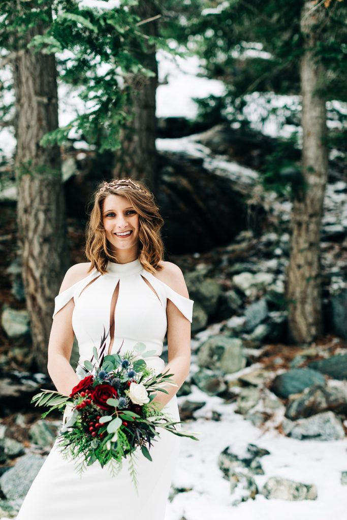 Mt. Baldy wedding photography ; bride smiling with green and red bouquet