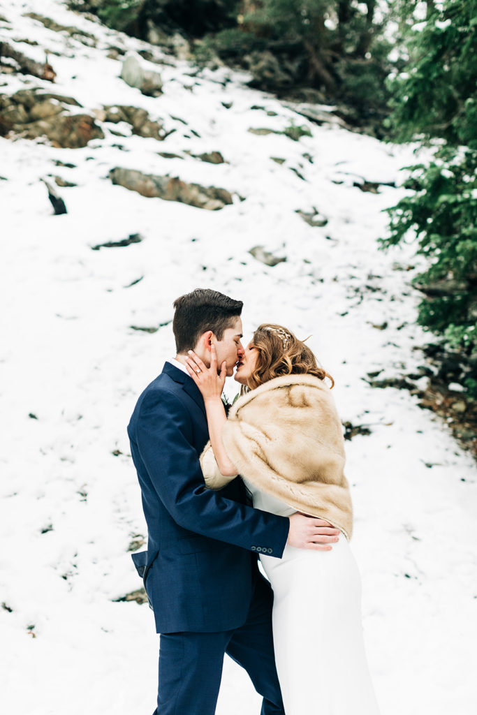 Mt. Baldy wedding photography ; bride and groom kiss in the snow