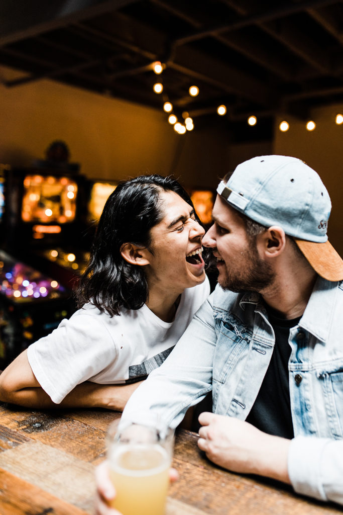 southern california engagement photos; gay couple laughing in an arcade