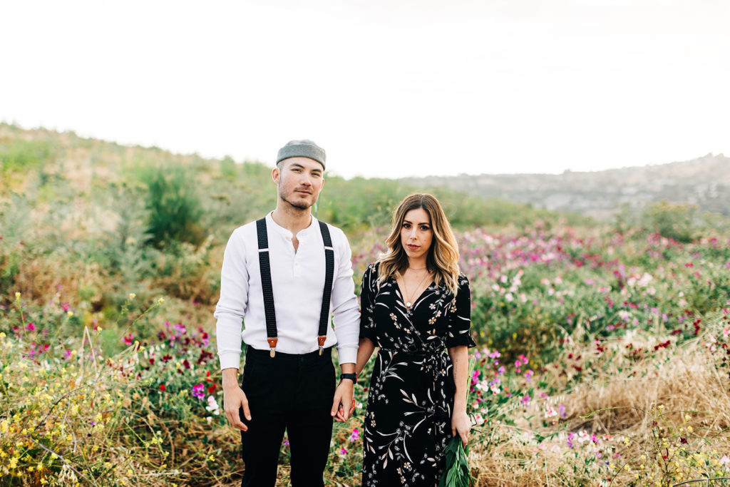 orange county engagement photos; couple standing in a flower field