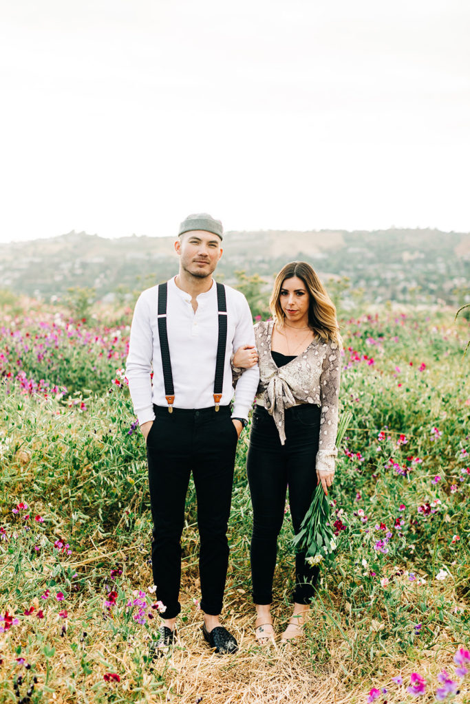 orange county engagement photos; couple standing in a flower field