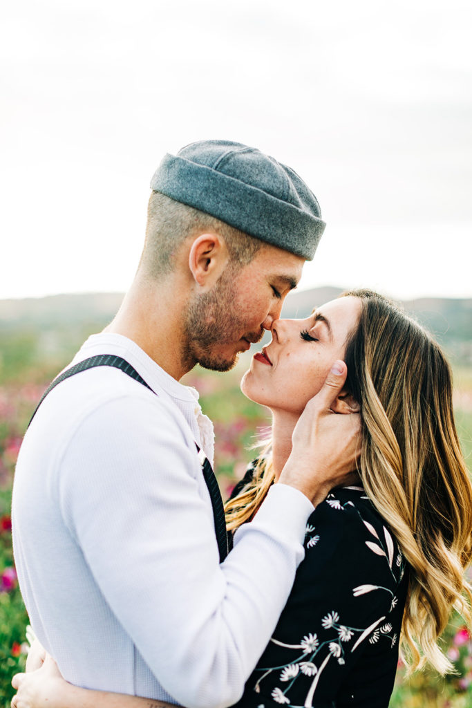 orange county engagement photos; man holds woman's face lovingly