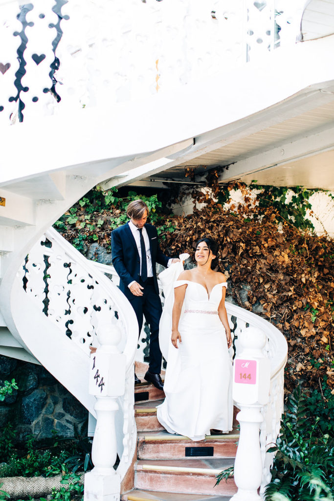 The Madonna Inn In San Luis Obispo, CA wedding photography; bride and groom coming downstairs