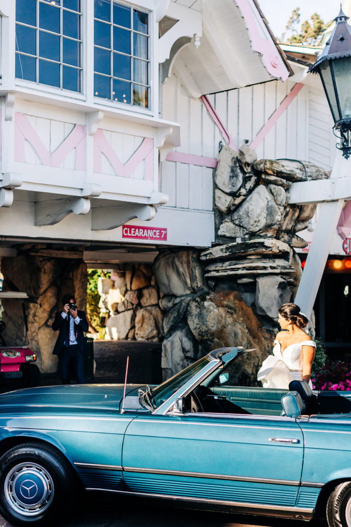 The Madonna Inn In San Luis Obispo, CA wedding photography; groom taking photo of her bride at the underpass