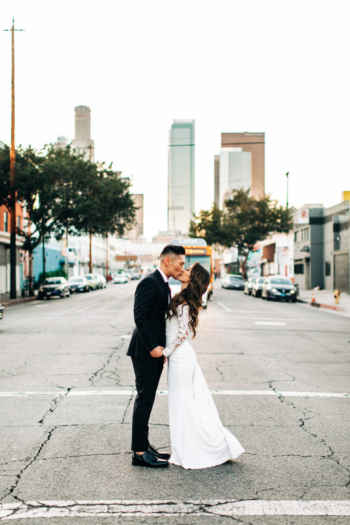 Valentine DTLA Wedding, Los Angeles wedding photographer; bride and groom kissing in the middle of the street with buildings in the background