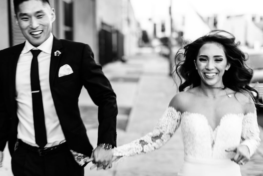 Valentine DTLA Wedding, Los Angeles wedding photographer; bride and groom holding hands and running towards the camera