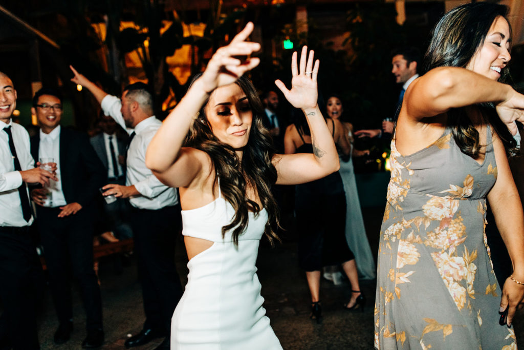 Valentine DTLA Wedding, Los Angeles wedding photographer; bride dancing at her wedding with friends and family