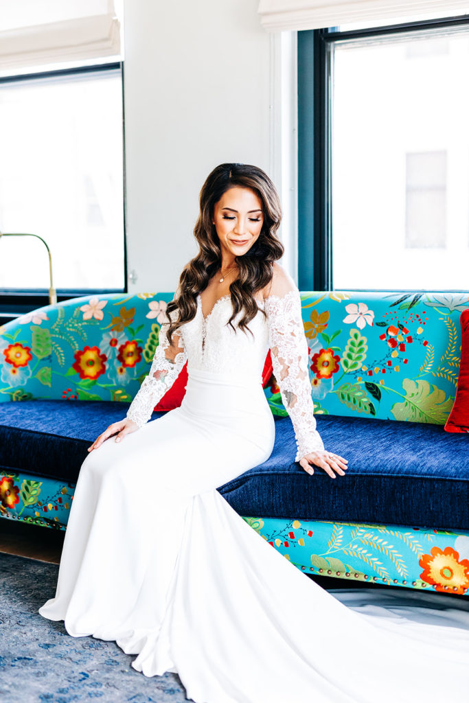 Valentine DTLA Wedding, Los Angeles wedding photographer; bride sitting on a printed couch in her wedding dress