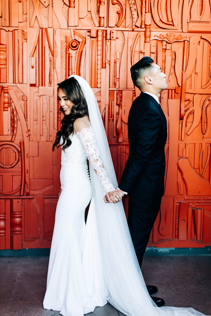 Valentine DTLA Wedding, Los Angeles wedding photographer; bride and groom back to back about to do a first look