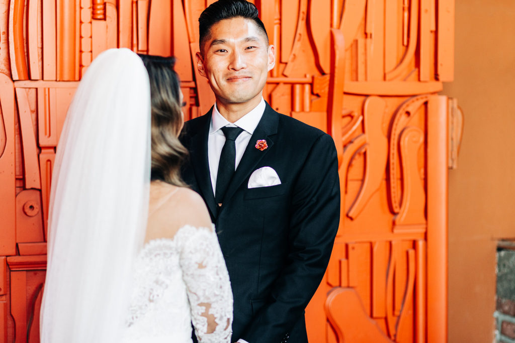 Valentine DTLA Wedding, Los Angeles wedding photographer; groom smiling at the camera while the bride looks at him