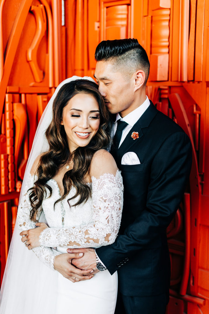 Valentine DTLA Wedding, Los Angeles wedding photographer; groom holding his bride close and kissing her on the head