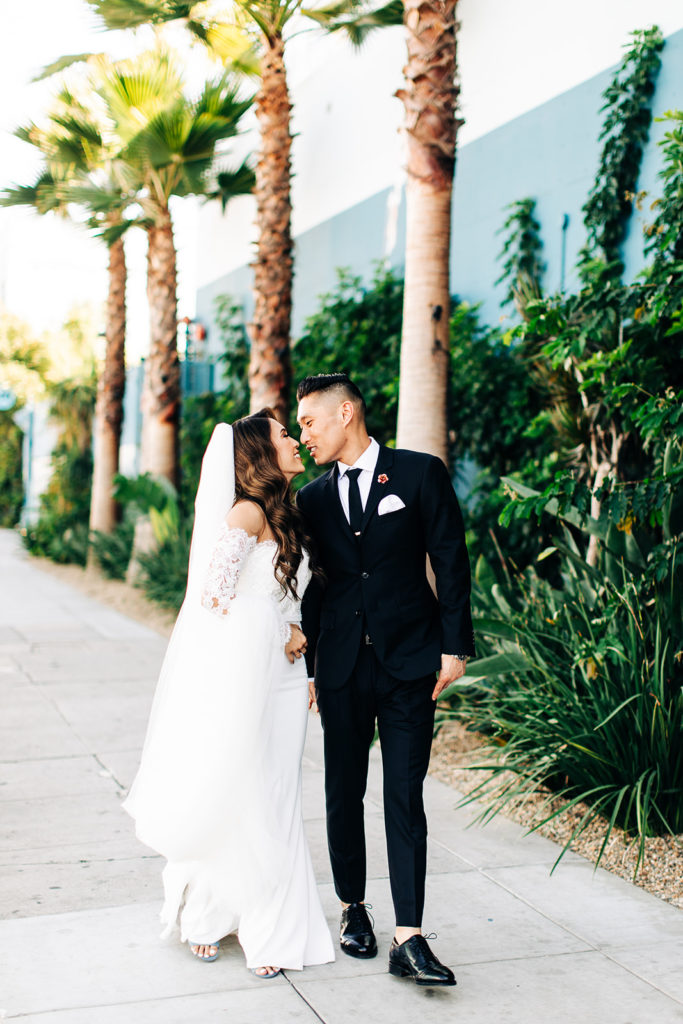 Valentine DTLA Wedding, Los Angeles wedding photographer; bride and groom walking down a sidewalk and looking at each other