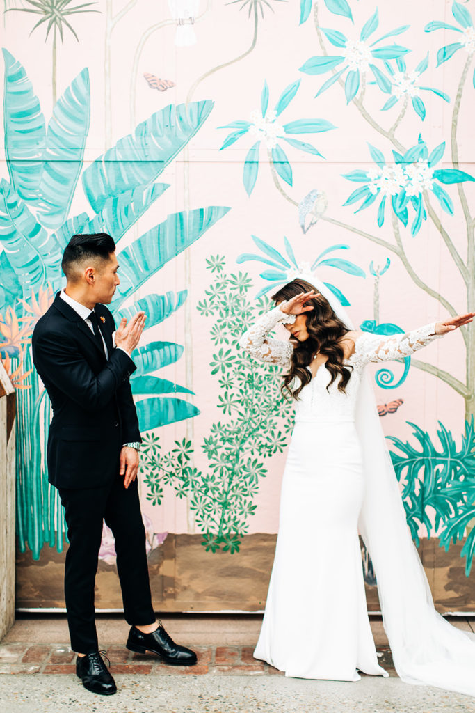 Valentine DTLA Wedding, Los Angeles wedding photographer; bride and groom dabbing in front of a colorful wall mural