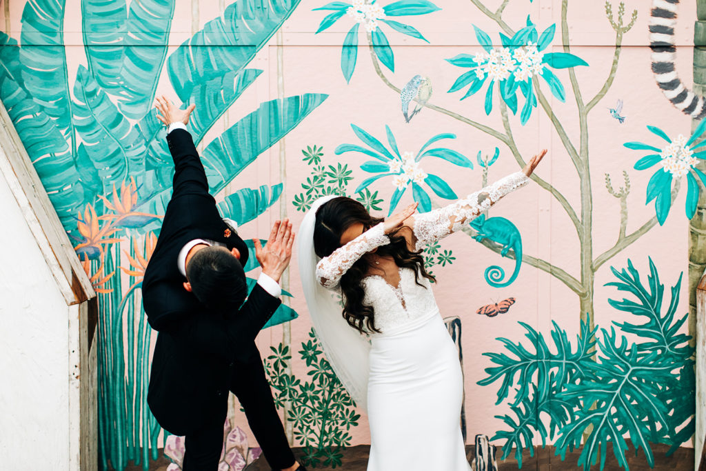Valentine DTLA Wedding, Los Angeles wedding photographer; bride and groom hitting the dab in front of a colorful wall mural
