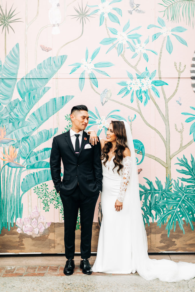 Valentine DTLA Wedding, Los Angeles wedding photographer; bride and groom standing and looking at each other in front of a colorful wall mural