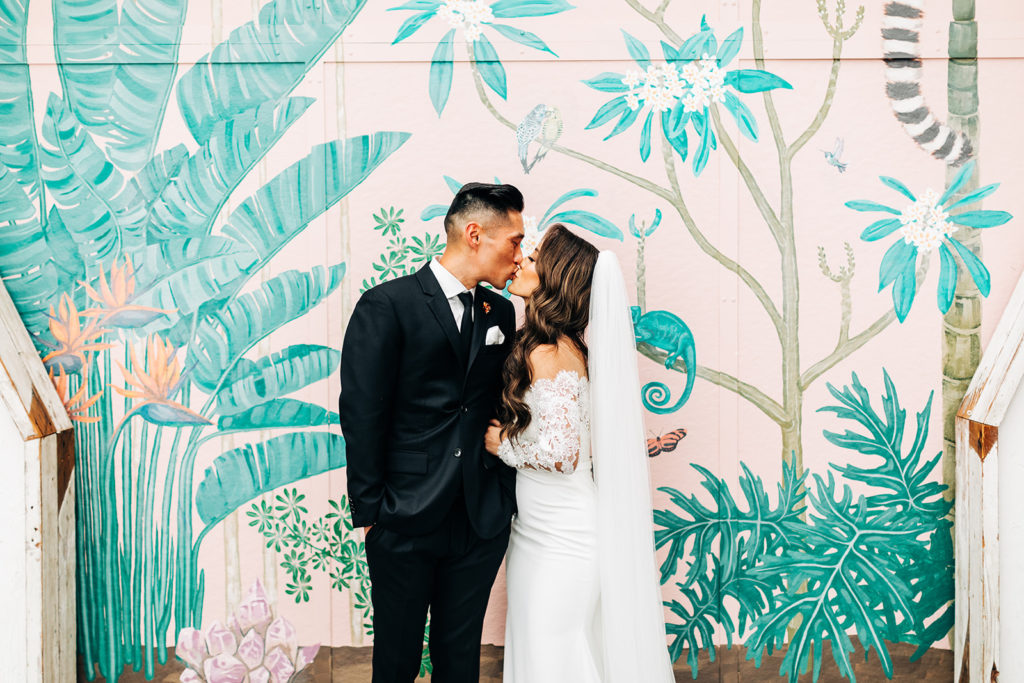 Valentine DTLA Wedding, Los Angeles wedding photographer; bride and groom kissing in front of a colorful wall mural