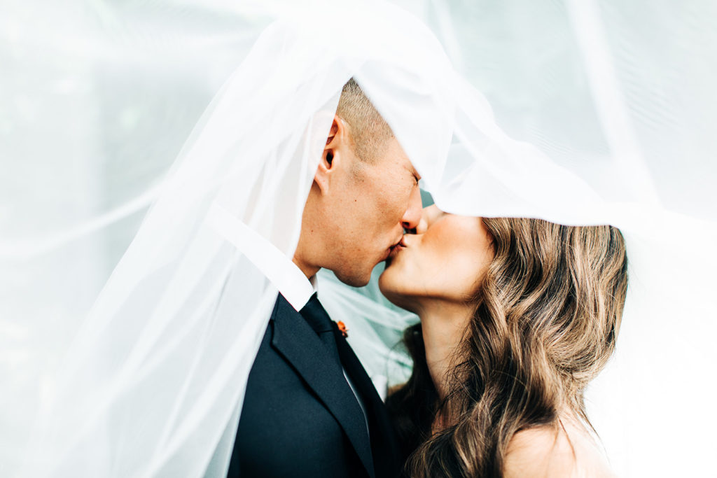 Valentine DTLA Wedding, Los Angeles wedding photographer; bride and groom kissing underneath the bride's veil