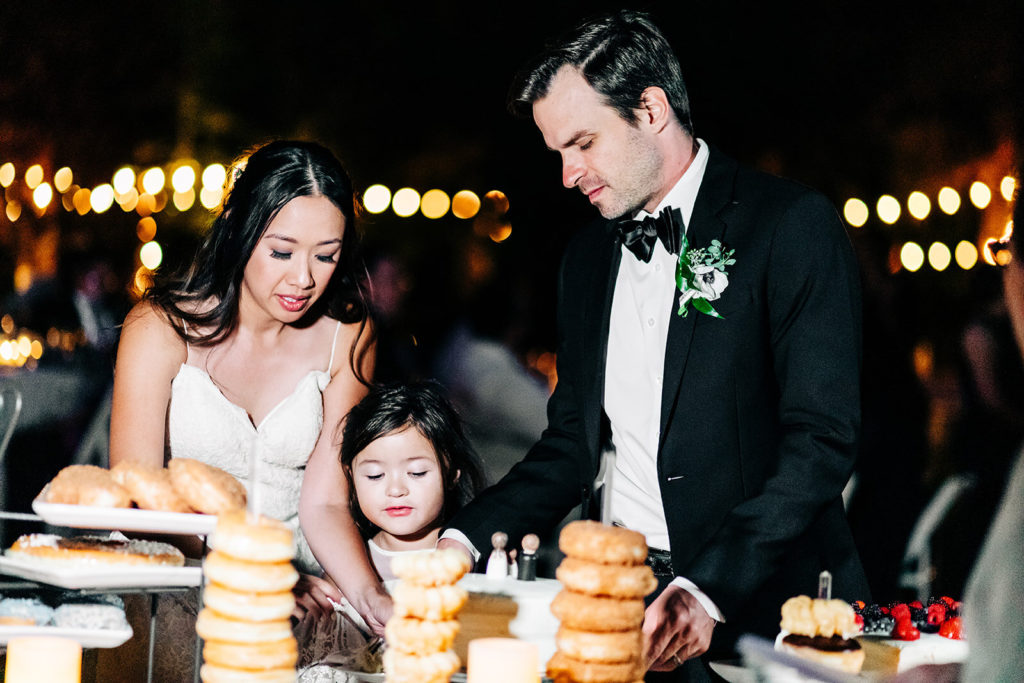 The Gold Mountain Manor In Big Bear, CA wedding photography; bride,groom and a little girl eating together