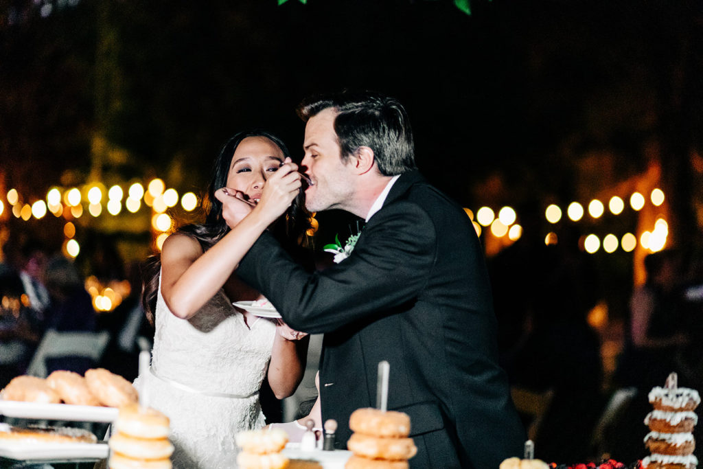 The Gold Mountain Manor In Big Bear, CA wedding photography; bride and groom eating wedding cake