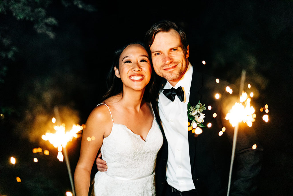 The Gold Mountain Manor In Big Bear, CA wedding photography; bride and groom holding sparklers