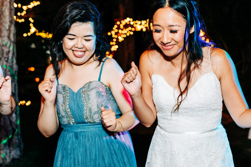 The Gold Mountain Manor In Big Bear, CA wedding photography; bride and bridesmaid dancing